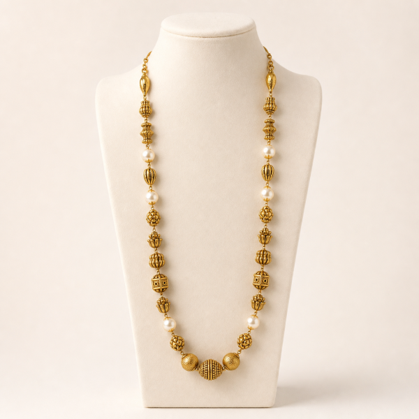 Tatva pearl gold mala on mannequin